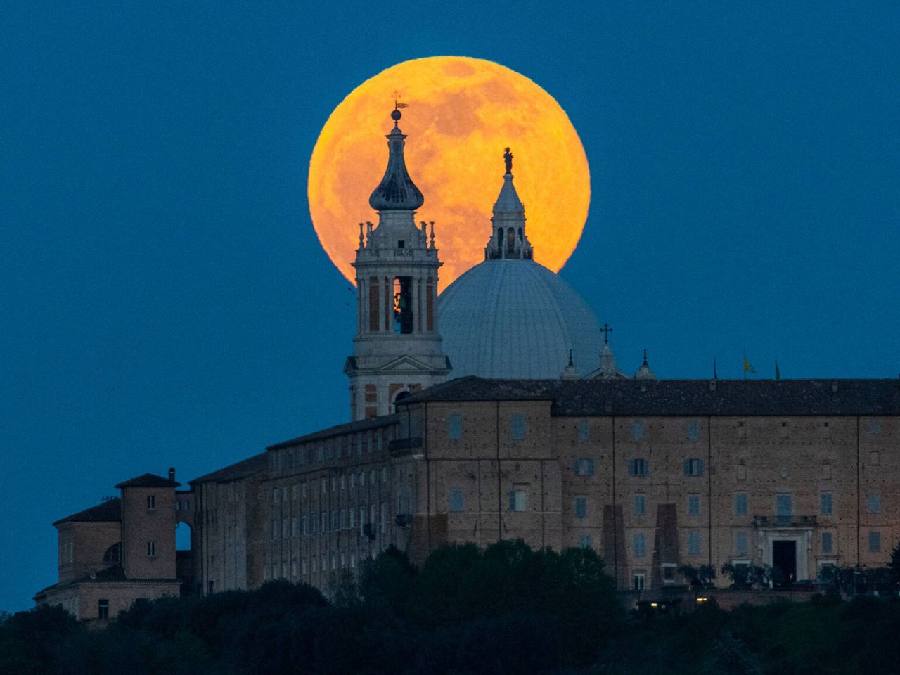 Der Vollmond steigt über der Stadt Loreto auf