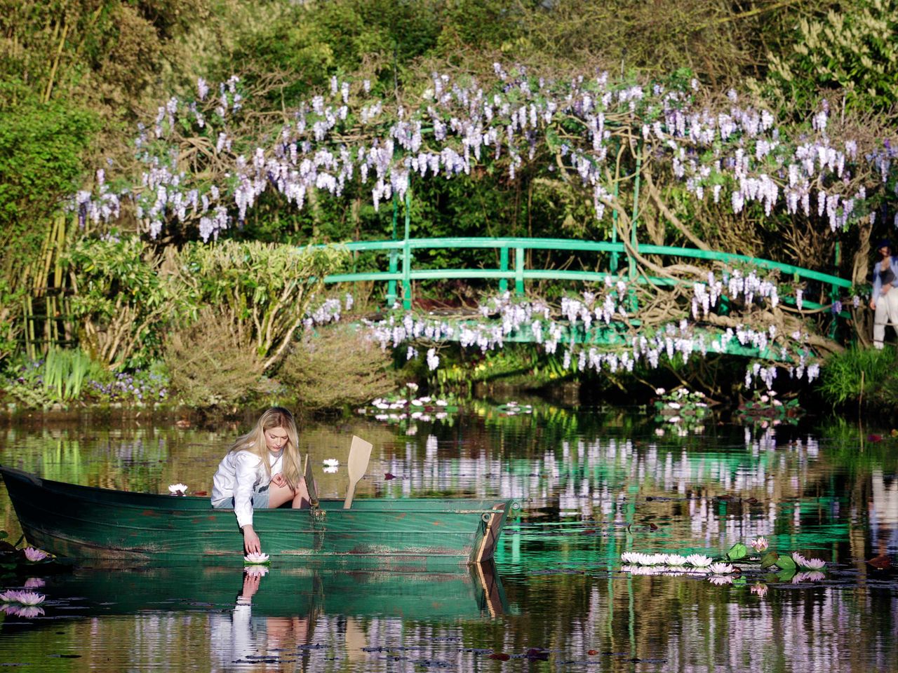 Camille (Camille Razat) auf dem berühmten Seerosenteich im Garten von Claude Monet (Emily in Paris)