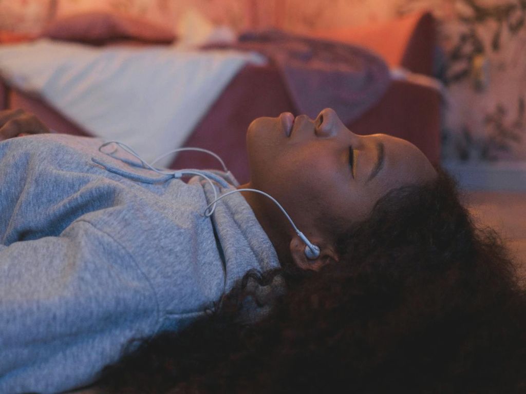 Frau hört über Kopfhörer Podcast