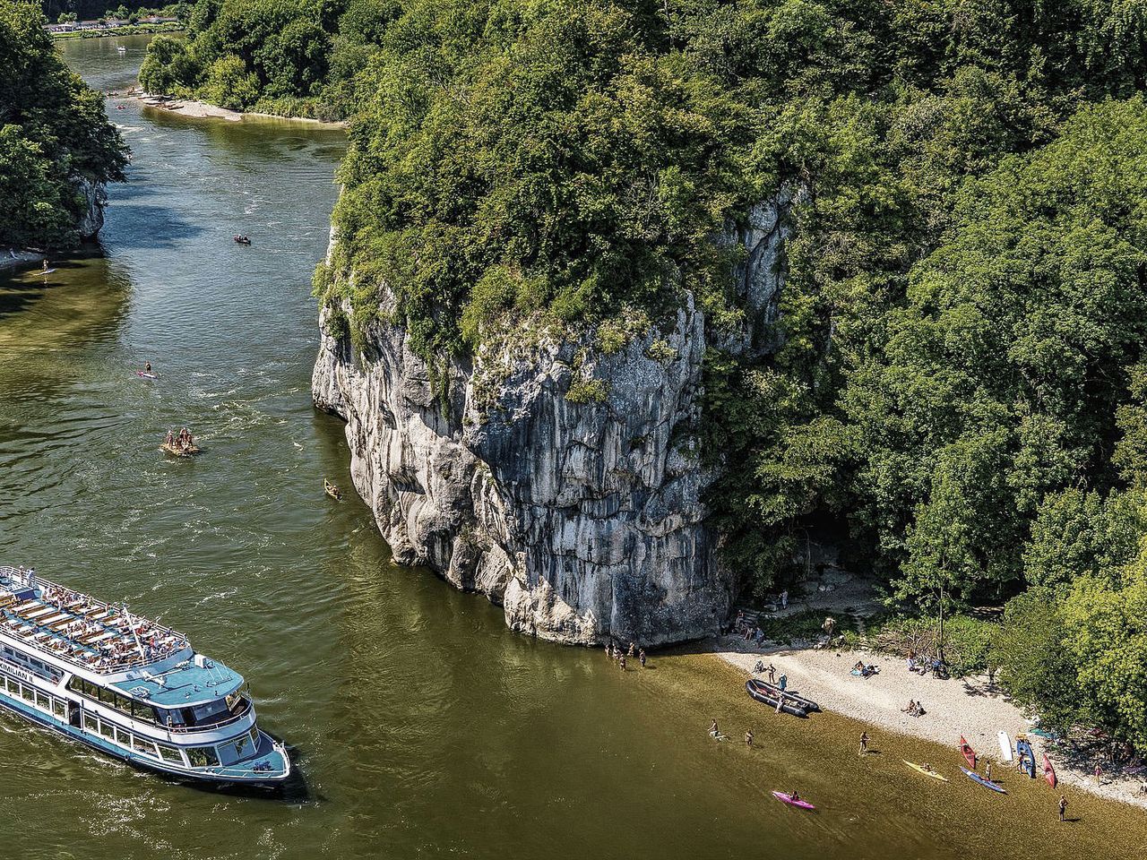 Ein Flusskreuzfahrtschiff fährt die Donau entlang